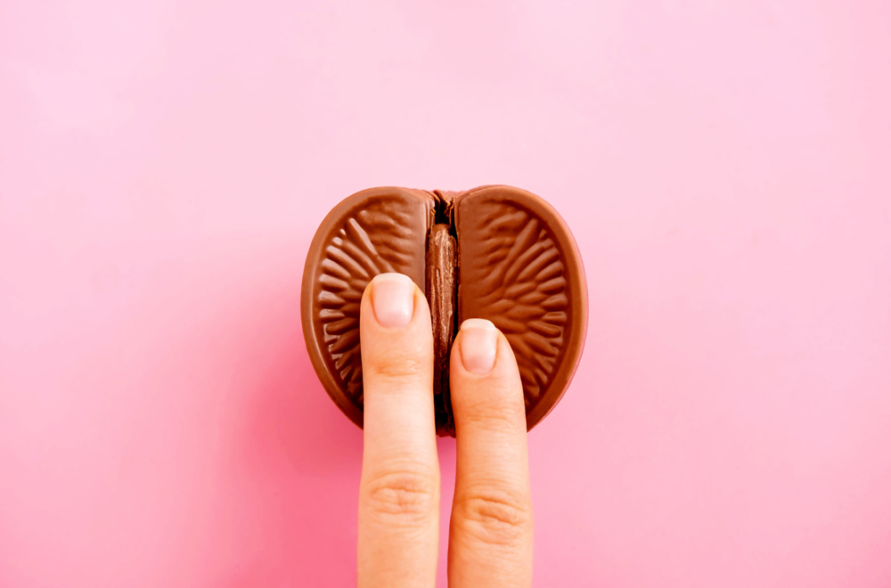 Two fingers touching chocolate orange segments