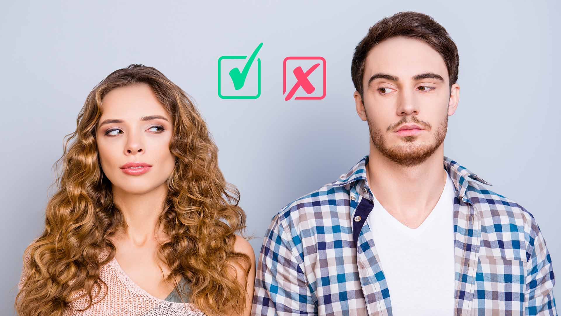 Blonde woman and brunette man standing next to each other and glancing at the green tick and red "x" mark between them.