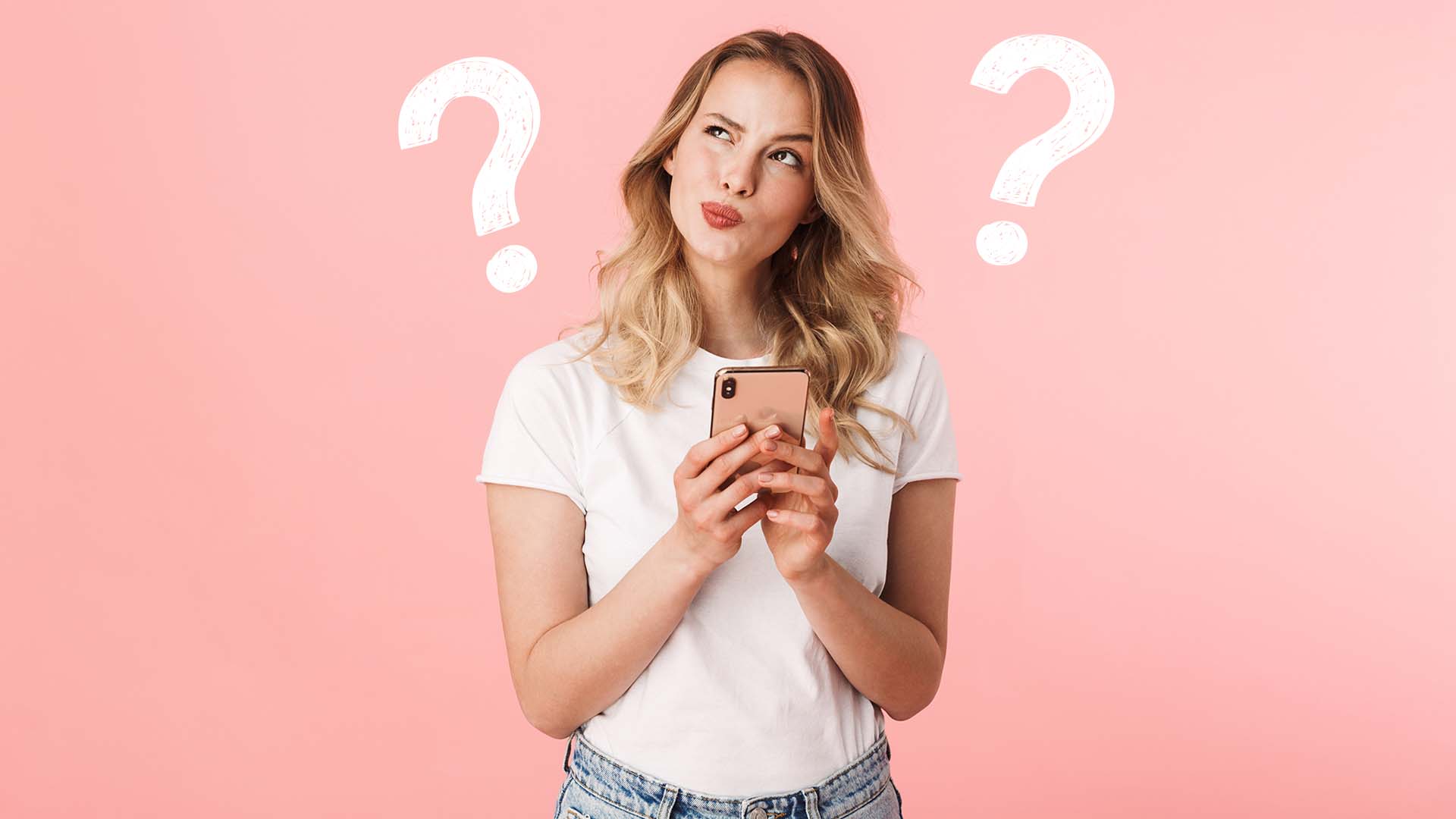 Younger blonde woman in white short-sleeved shirt holding her phone and looking confused with two question marks next to her.